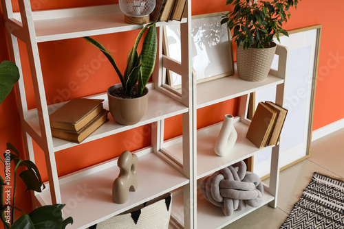 White bookshelf with plants...