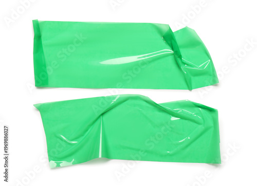 Crumpled strips of green ad...