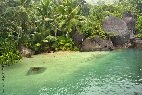 Beautiful small beach with granite stones and white sandy beach at cap ternay, Mahe, Seychelles