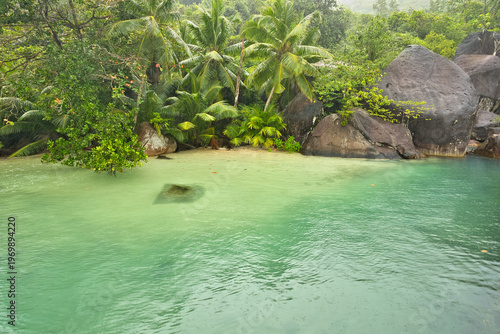 Beautiful small beach with granite stones and white sandy beach at cap ternay, Mahe, Seychelles