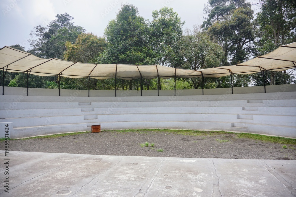 custom made wallpaper toronto digitalOpen-air amphitheater with tiered seating and canopy in a green environment.