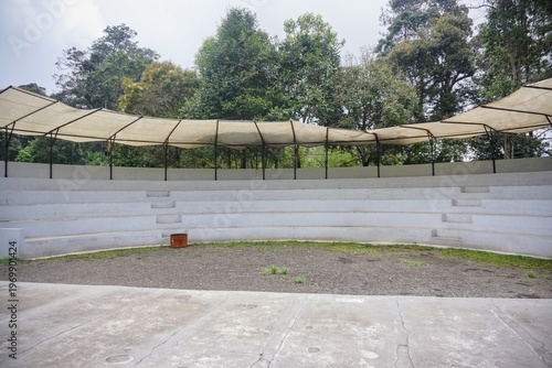 Wallpaper Mural Open-air amphitheater with tiered seating and canopy in a green environment. Torontodigital.ca
