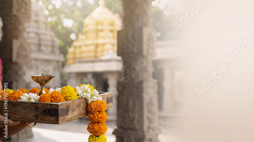 Traditional Hindu Puja Offering with Marigold Flowers and Oil Lamp in Ancient Temple Background