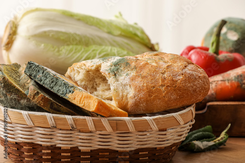 Quadro em tela Wicker basket with moldy vegetables, cheese and bread on counter in kitchen