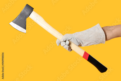 Hand in glove holding ax on...