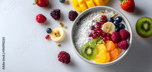 Fresh fruit and oatmeal bowl with mixed berries sliced banana and kiwi on a white background with scattered fruit and soft natural lighting