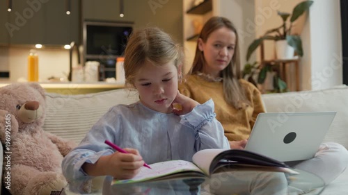 Mother and child balancing remote work and learning at home