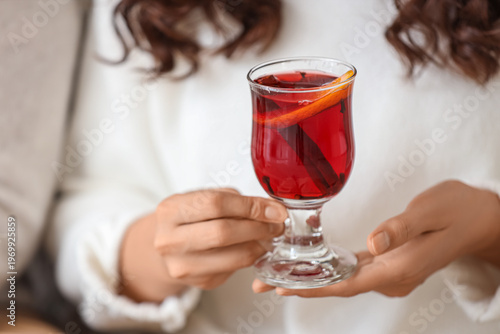 Young woman with glass cup ...