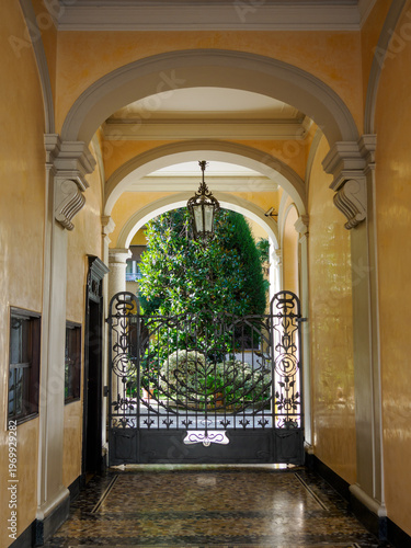 Old residential building along Via Caradosso in Milan, Italy. Entryway