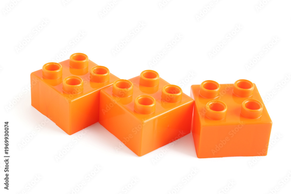 Fototapeta premium Orange plastic building blocks on white background