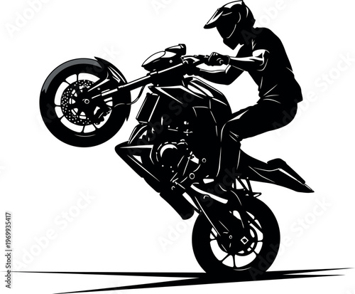 Silhouette of a motorcyclist performing a wheelie on a dirt bike