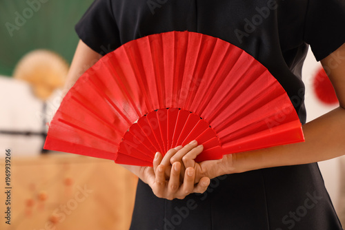 Young Asian woman with fan ...