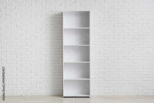 Empty bookshelf near white ...