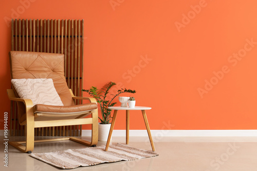 Interior of living room with armchair, coffee table and folding screen