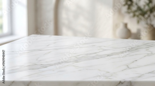 A close-up view of a white marble countertop in a bright room