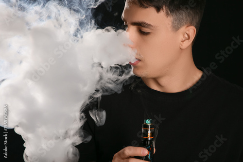 Young man smoking electroni...