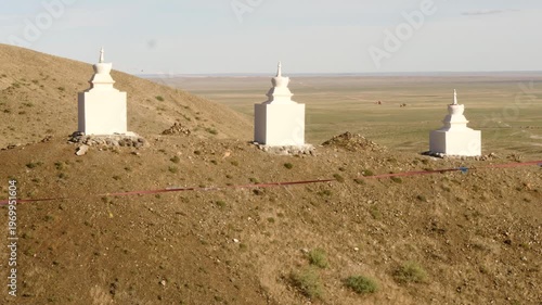  Sacred Buddhist stupa structures among the red sandy hills of the Gobi Desert, Mongolia.