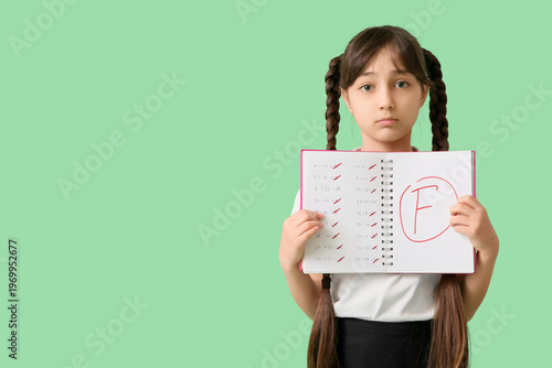 Sad schoolgirl holding note...