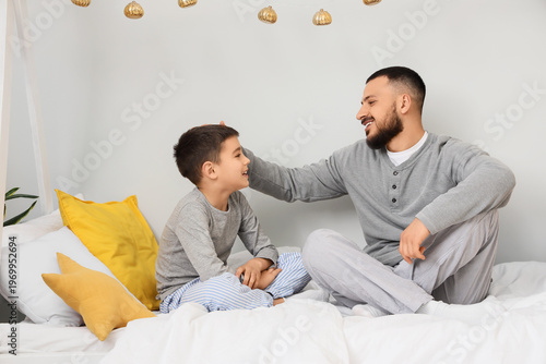 Happy father in pajamas spe...