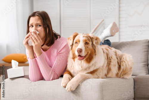 Young sneezing woman and do...