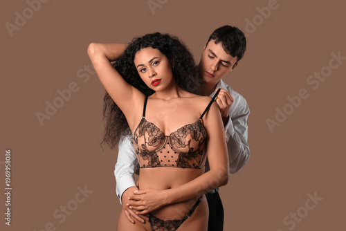 Sexy young couple on brown ...