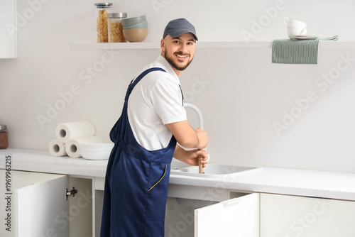 Male plumber with plunger c...