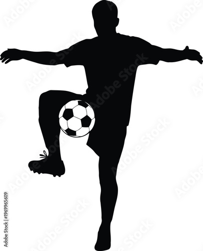 Silhouette of a soccer player balancing a ball on his knee during practice