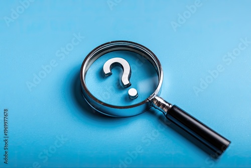 Magnifying glass over a metallic question mark on a vibrant blue background