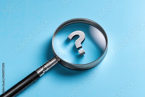 A magnifying glass focuses on a metallic question mark on a bright blue background