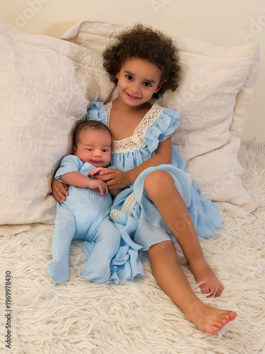 African girl with baby brother