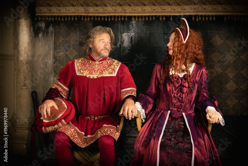 Renaissance king and queen sitting on thrones