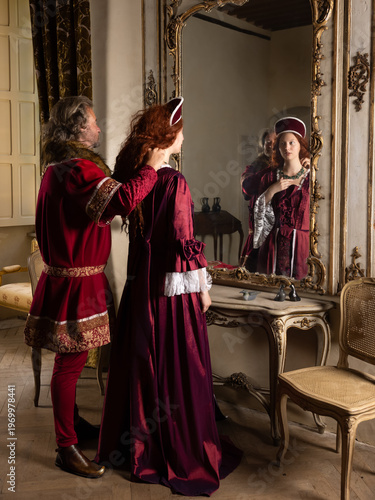 Tudor queen and king putting on jewellery