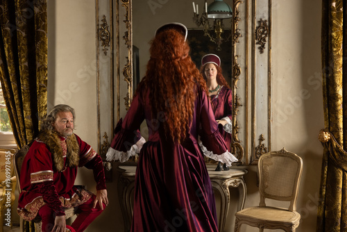 Tudor queen and king at mirror