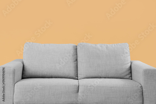 Cozy grey sofa on beige bac...