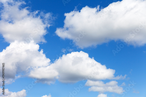 Beautiful sky landscape of cumulus clouds in sunny blue sky. Light cloud cover on nice summer weather.  Natural background of different shades of blue color