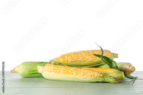 Fresh corn cobs on green wo...