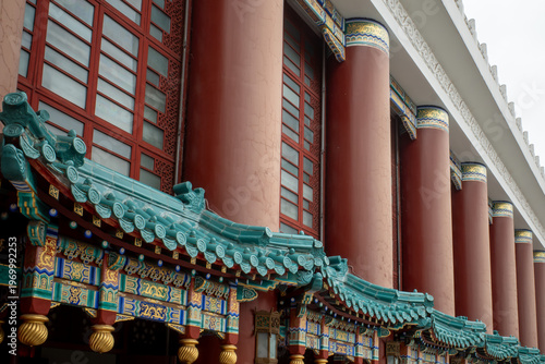 Fotografie Grand building with red pillars and green tiled roof