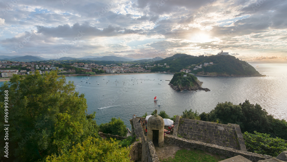 Naklejka premium Sunset view of La Concha bay with Santa Clara island from Monte Urgull in San Sebastian, Basque Country, Spain