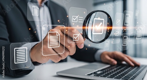 Businessman using laptop and magnifying glass for document management and data analysis.
