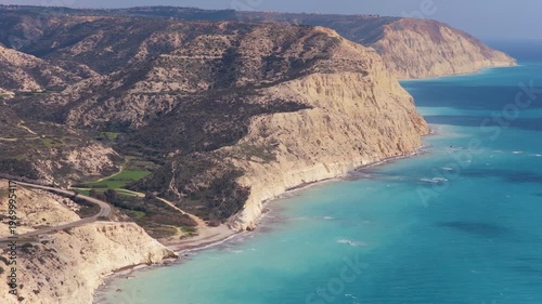Aerial drone view of dramatic white cliffs meeting the turquoise Mediterranean Sea in Cyprus