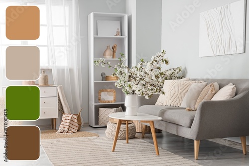 Interior of light living room with blooming spring branches. Different color patterns