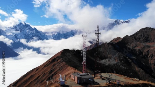Secluded Communications Mast Atop Frosty Ridges Overlooking Thick Fog And Pristine Mountain Vistas. Media