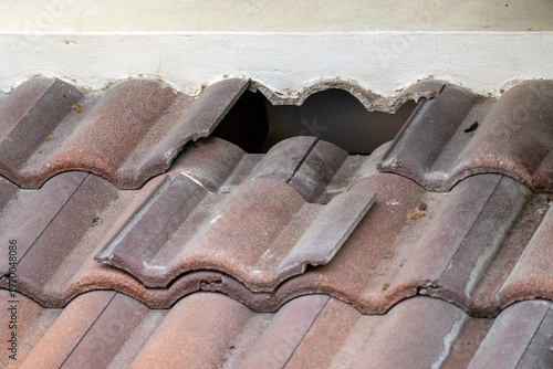 Damaged old roof tile in need of repair.