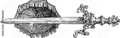 Ornate vintage sword with detailed hilt and straight blade on wooden log cross section