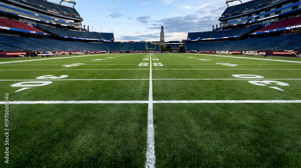 Fototapeta premium Empty American Football Stadium Field with Yard Lines and Goal Posts at Sunset