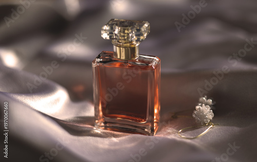 Luxury women’s perfume with elegant earrings on silk background, premium beauty and fashion concept
