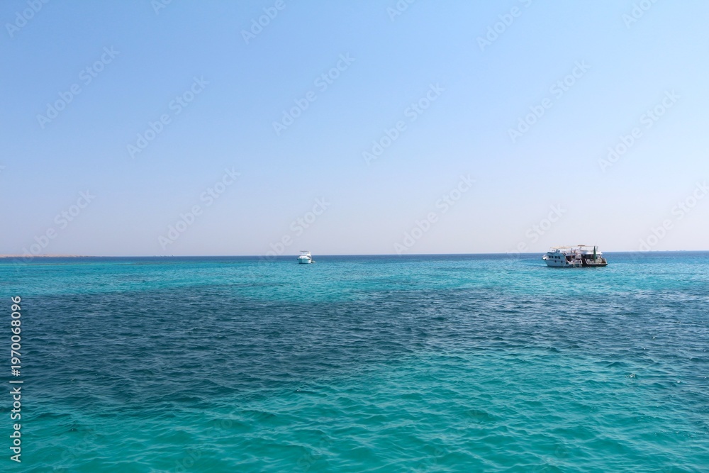 Fototapeta premium Tropical Ocean with Boats Under a Clear Sky. High quality photo