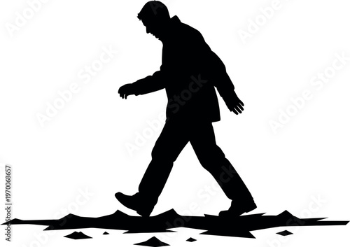 Silhouette of a man walking through broken pieces