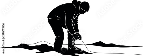 Silhouette of a person standing on a mountain peak at sunset