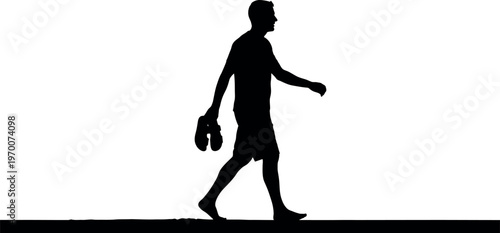 Silhouette of a man walking with a hat in hand